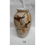 A Chinese/Oriental vase depicting birds, flowers and grasses. Approximate height 24cm/ 9 1/2".