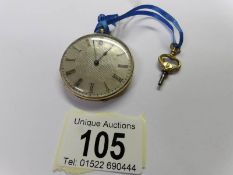 An 18ct gold and enamel pocket watch with key and in working order.