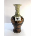 A small Royal Doulton vase depicting twigs with leaves in brown with a mottled grey/green top.