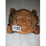 A 19th century carved wood 'Facial' plaque.