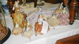 A collection of pin cushion dolls