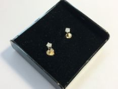 A pair of white gold and diamond ear studs.