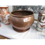 A large copper pot and a copper tray.