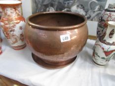 A large copper pot and a copper tray.