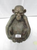 A heavy brass seated monkey.