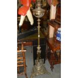 A very heavy ornate brass standard oil lamp