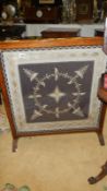 A large oak framed firescreen with lace & gold/silver thread panel