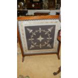 A large oak framed firescreen with lace & gold/silver thread panel