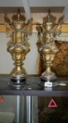 A pair of lidded spelter urns