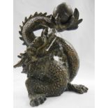 An old bronze dragon holding a ball.