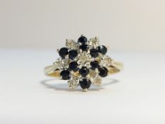 A 9ct gold sapphire and diamond cluster ring, hall marked HAN, Birmingham 1986, size O.