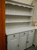 A painted open rack 3 door, 3 drawer dresser.