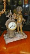 A clock with cherub on marble base