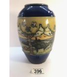 A Royal Doulton vase with attractive stylised country scene showing trees, birds, hedges,