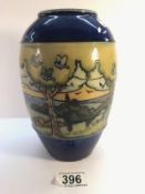 A Royal Doulton vase with attractive stylised country scene showing trees, birds, hedges,