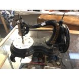 An early Victorian hand cranked sewing machine.