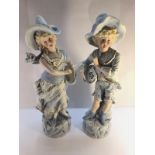 A pair of 19th century porcelain figures, 33 cm tall.