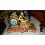 A French mantel clock on marble base.