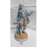 A 19th century continental porcelain figure of a gentleman, 30 cm tall.