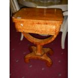 A Victorian sewing/games table in satin wood.