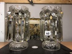 A pair of heavy cut glass candle holders with crystal droppers.
