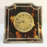 A silver and tortoise shell 8 day clock.