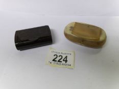 A 19th century horn snuff box and a bakelite snuff box.