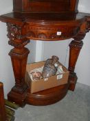 A mahogany corner stand with lion head carvings.