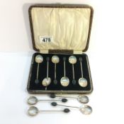 A cased set of 6 silver coffee bean spoons and 4 extra.