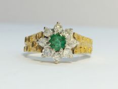 An 18ct yellow gold circular diamond ring with centre emerald, size K.