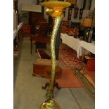 A modern gilded table lamp in the form of a snake.