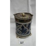 A Doulton Lambeth biscuit barrel with metal stand on three round feet and metal lid with a round