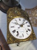 A 1900's French Meunier porcelain clock movement with bracket for wall mounting.