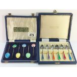 A cased set of 6 silver and enamel spoons together with a cased set of enamel spoons.