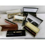 A collection of cased pen sets.