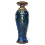 A Royal Doulton vase No. 7574 featuring a pattern of circles on leaves on a blotchy blue ground.