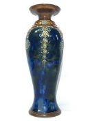 A Royal Doulton vase No. 7574 featuring a pattern of circles on leaves on a blotchy blue ground.