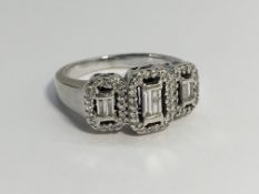 An 18ct white gold baguette and brilliant cut diamond ring, size O.