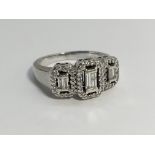 An 18ct white gold baguette and brilliant cut diamond ring, size O.