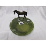 A cold cast bronze horse on an onyx dish.