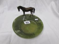A cold cast bronze horse on an onyx dish.