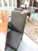 A set of 4 modern upholstered dining chairs.