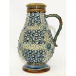 An 1879 Doulton Lambeth vase with handle by Harriet E Hibbut featuring a pattern of flowers,