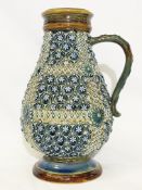 An 1879 Doulton Lambeth vase with handle by Harriet E Hibbut featuring a pattern of flowers,