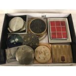 A collection of powder compacts.