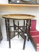 A folding table with brass top.