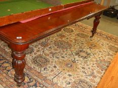 A Victorian mahogany wind out table.