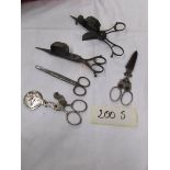 A quantity of Victorian oil lamp wick cutters and other scissors.