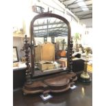 A Victorian mahogany toilet mirror with storage compartment.