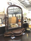 A Victorian mahogany toilet mirror with storage compartment.